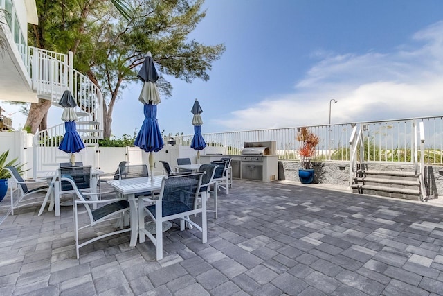 19816 Gulf Blvd Unit 201, Indian Shores, FL 33785 - view of patio with area for grilling, outdoor dining area, and a fenced backyard