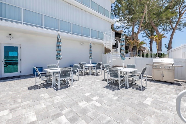 19816 Gulf Blvd Unit 201, Indian Shores, FL 33785 - view of patio featuring stairway, fence, outdoor dining area, and a grill