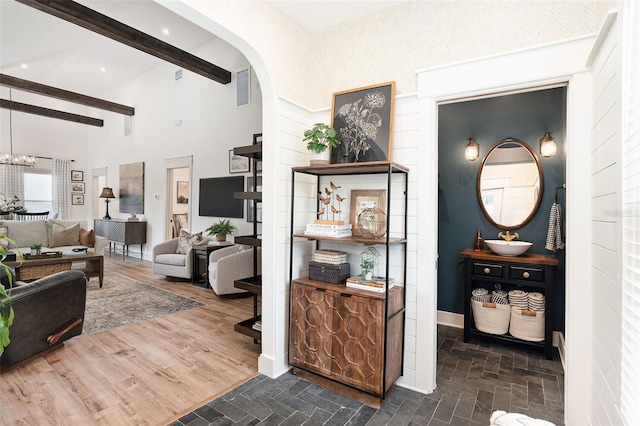 2910 W Aquilla St, Tampa, FL 33629 - foyer entrance with beam ceiling, arched walkways, a chandelier, and a high ceiling
