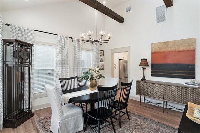 2910 W Aquilla St, Tampa, FL 33629 - dining area with wood finished floors, a chandelier, high vaulted ceiling, healthy amount of natural light, and beam ceiling