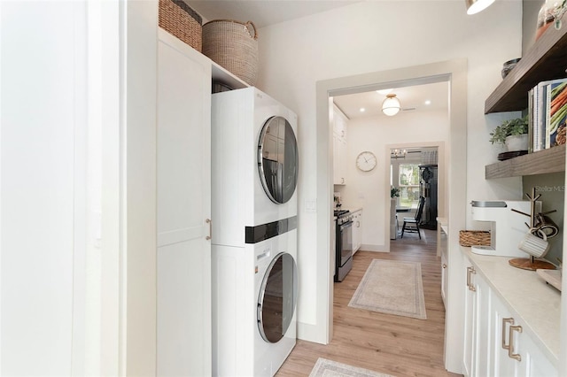2910 W Aquilla St, Tampa, FL 33629 - washroom with stacked washer / drying machine, light wood finished floors, and baseboards