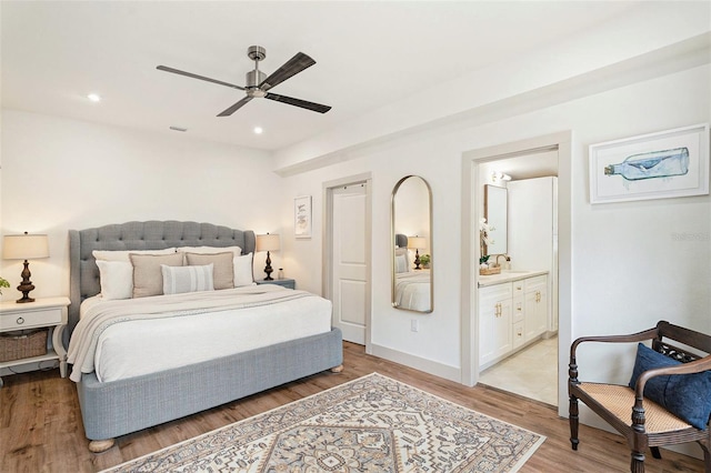 2910 W Aquilla St, Tampa, FL 33629 - bedroom with light wood-type flooring, ensuite bath, a ceiling fan, recessed lighting, and a sink