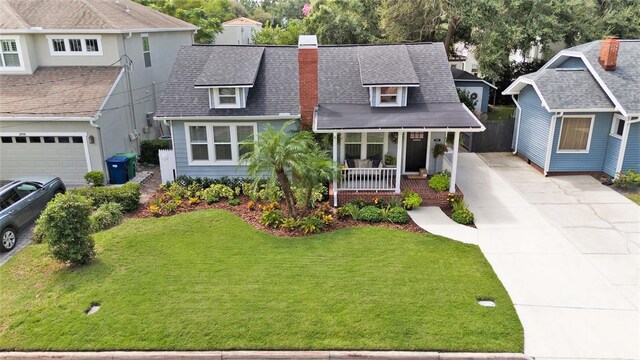 2910 W Aquilla St, Tampa, FL 33629 - view of front of house with covered porch, driveway, a front lawn, and a shingled roof