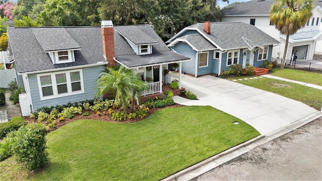 2910 W Aquilla St, Tampa, FL 33629 - view of front of home featuring a chimney, a porch, driveway, and a shingled roof