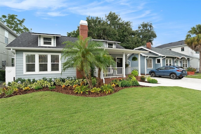 2910 W Aquilla St, Tampa, FL 33629 - view of front of house with covered porch, a front lawn, concrete driveway, and a shingled roof