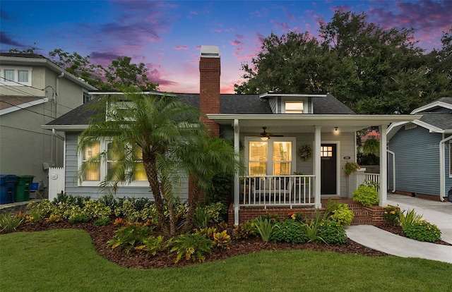 2910 W Aquilla St, Tampa, FL 33629 - view of front of property with a porch, a chimney, a front lawn, ceiling fan, and a shingled roof