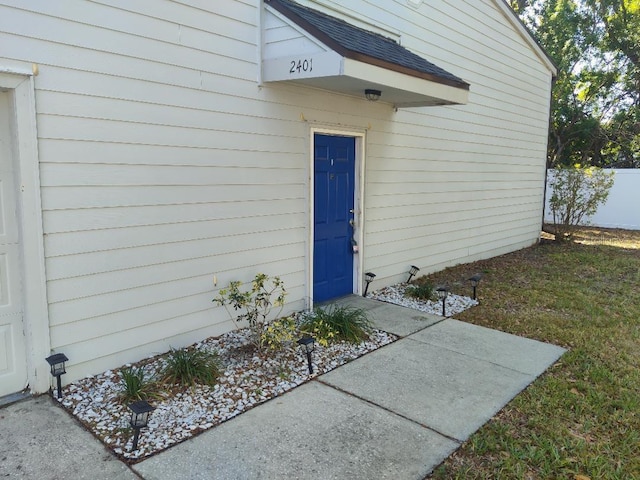 entrance to property featuring fence