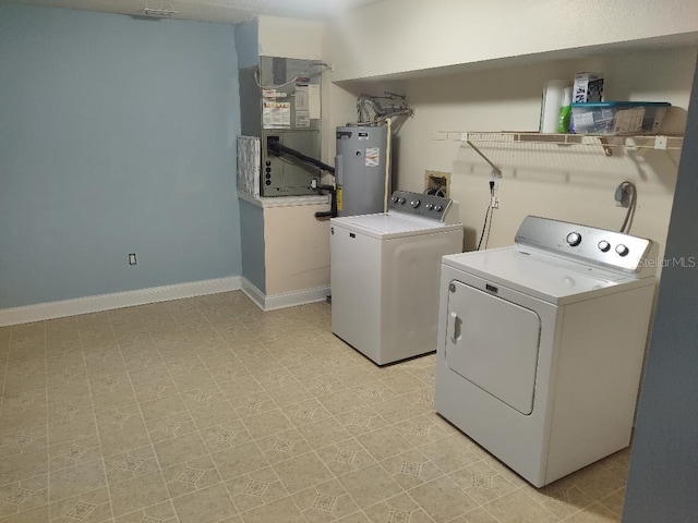 washroom with water heater, heating unit, independent washer and dryer, and laundry area