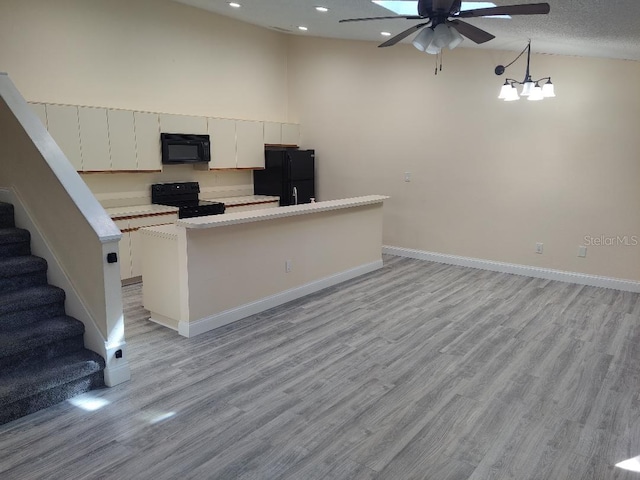 kitchen with light countertops, light wood-type flooring, baseboards, ceiling fan, and black appliances
