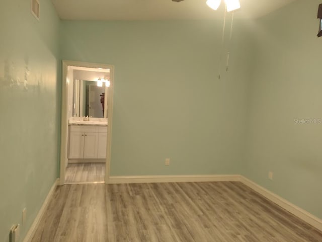 unfurnished bedroom with baseboards, visible vents, and light wood-style flooring