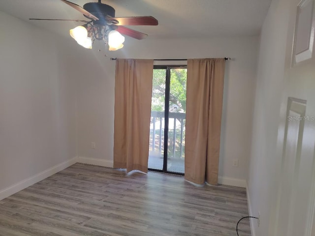 empty room featuring baseboards, ceiling fan, and wood finished floors