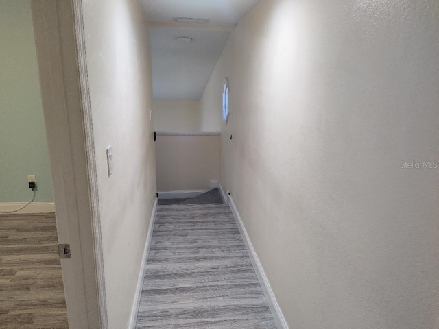 staircase featuring baseboards, visible vents, and wood finished floors