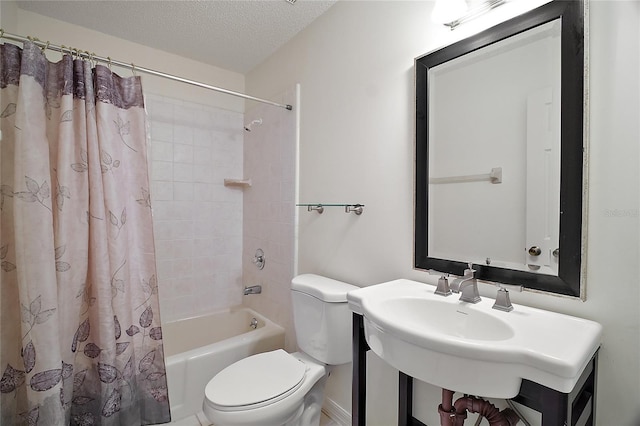 bathroom with a sink, a textured ceiling, shower / bath combo, and toilet