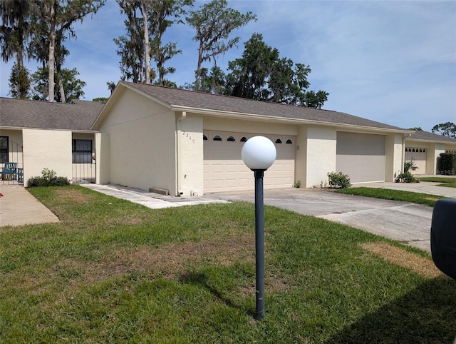 view of property exterior with a lawn, stucco siding, and driveway