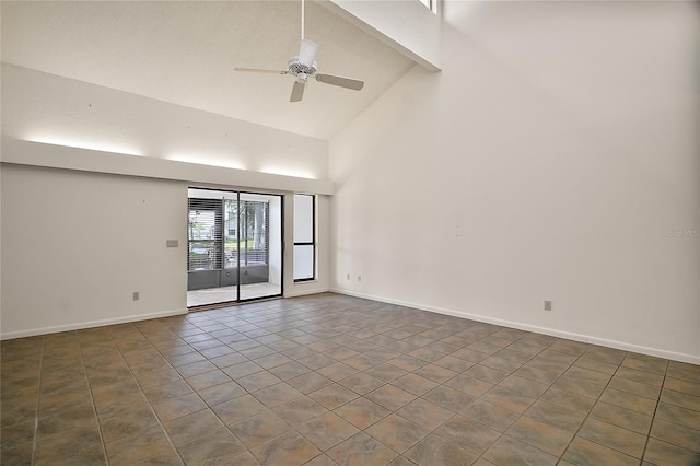 spare room with tile patterned floors, ceiling fan, baseboards, and high vaulted ceiling