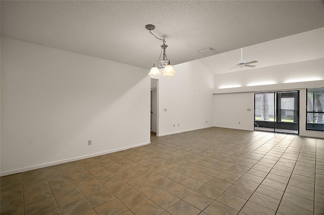 unfurnished room with tile patterned floors, baseboards, vaulted ceiling, and a textured ceiling