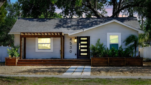 4530 5th Ave S, Saint Petersburg, FL 33711 - view of front facade with a shingled roof and fence