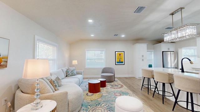 4530 5th Ave S, Saint Petersburg, FL 33711 - living room featuring light wood-style floors, recessed lighting, and baseboards