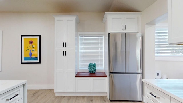4530 5th Ave S, Saint Petersburg, FL 33711 - kitchen featuring freestanding refrigerator, light wood-type flooring, white cabinetry, light countertops, and baseboards