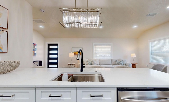 4530 5th Ave S, Saint Petersburg, FL 33711 - kitchen with a sink, stainless steel dishwasher, lofted ceiling, open floor plan, and white cabinets