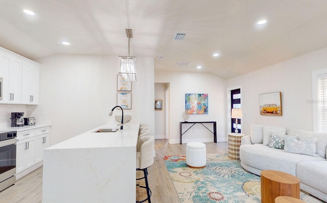 4530 5th Ave S, Saint Petersburg, FL 33711 - kitchen featuring a sink, lofted ceiling, range, a kitchen bar, and open floor plan