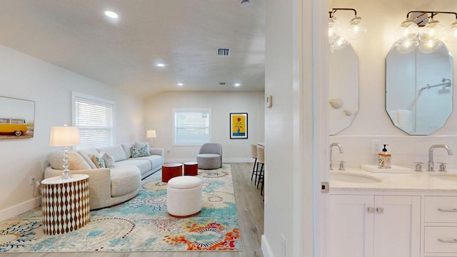 4530 5th Ave S, Saint Petersburg, FL 33711 - living area with recessed lighting, baseboards, light wood finished floors, and wet bar