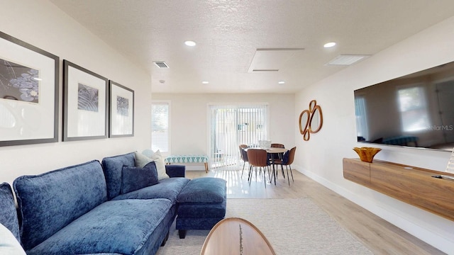 4530 5th Ave S, Saint Petersburg, FL 33711 - living room with light wood finished floors, attic access, recessed lighting, baseboards, and a textured ceiling