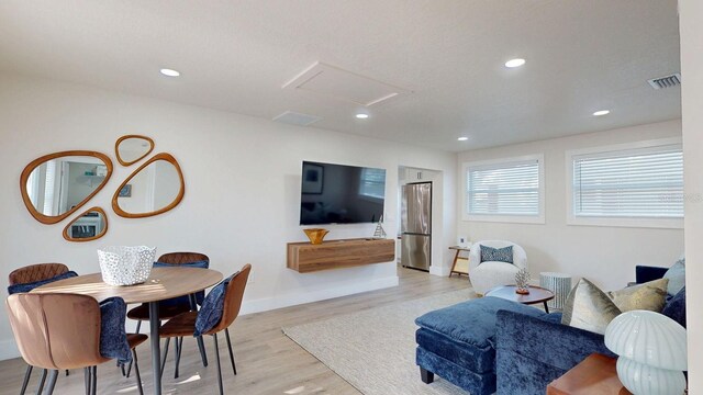 4530 5th Ave S, Saint Petersburg, FL 33711 - living area with light wood-style floors, attic access, recessed lighting, and baseboards