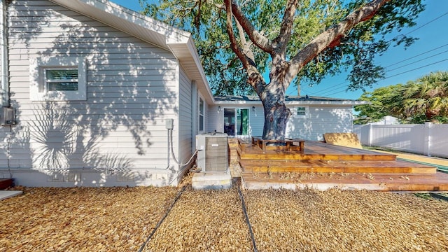 4530 5th Ave S, Saint Petersburg, FL 33711 - view of property exterior with a deck, central AC unit, and fence