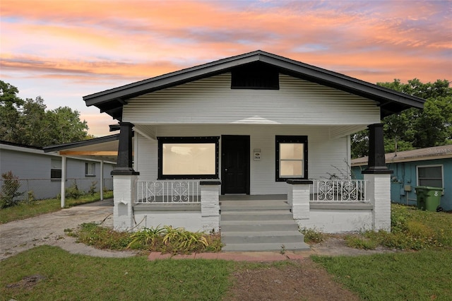 2920 E 20th Ave, Tampa, FL 33605 - view of front of home with fence, driveway, a carport, and a porch