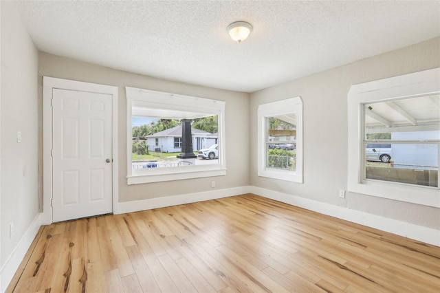 2920 E 20th Ave, Tampa, FL 33605 - empty room with a textured ceiling, baseboards, and wood finished floors