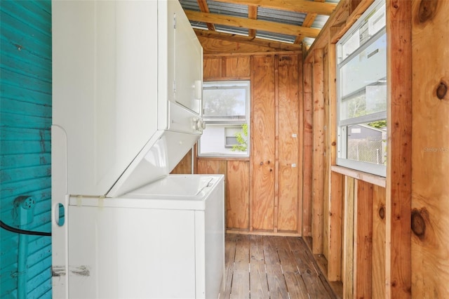 2920 E 20th Ave, Tampa, FL 33605 - laundry room featuring stacked washer and clothes dryer, wood walls, laundry area, and hardwood / wood-style floors
