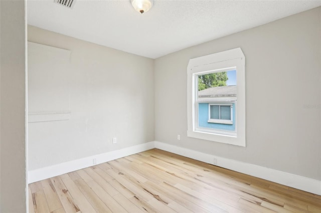 2920 E 20th Ave, Tampa, FL 33605 - spare room featuring visible vents, a textured ceiling, baseboards, and wood finished floors