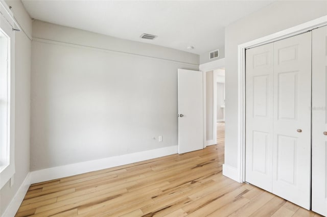 2920 E 20th Ave, Tampa, FL 33605 - unfurnished bedroom with baseboards, visible vents, a closet, and light wood-style floors