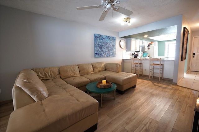 7360 Ulmerton Rd Unit 29B, Largo, FL 33771 - living area featuring light wood finished floors, ceiling fan, and a textured ceiling