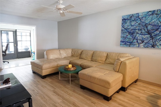 7360 Ulmerton Rd Unit 29B, Largo, FL 33771 - living room featuring light wood-style floors, ceiling fan, and a textured ceiling