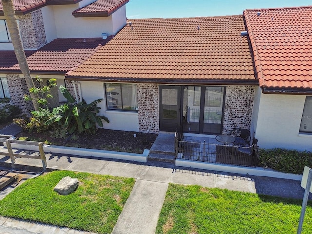 7360 Ulmerton Rd Unit 29B, Largo, FL 33771 - view of front of house with a tile roof, french doors, and stucco siding