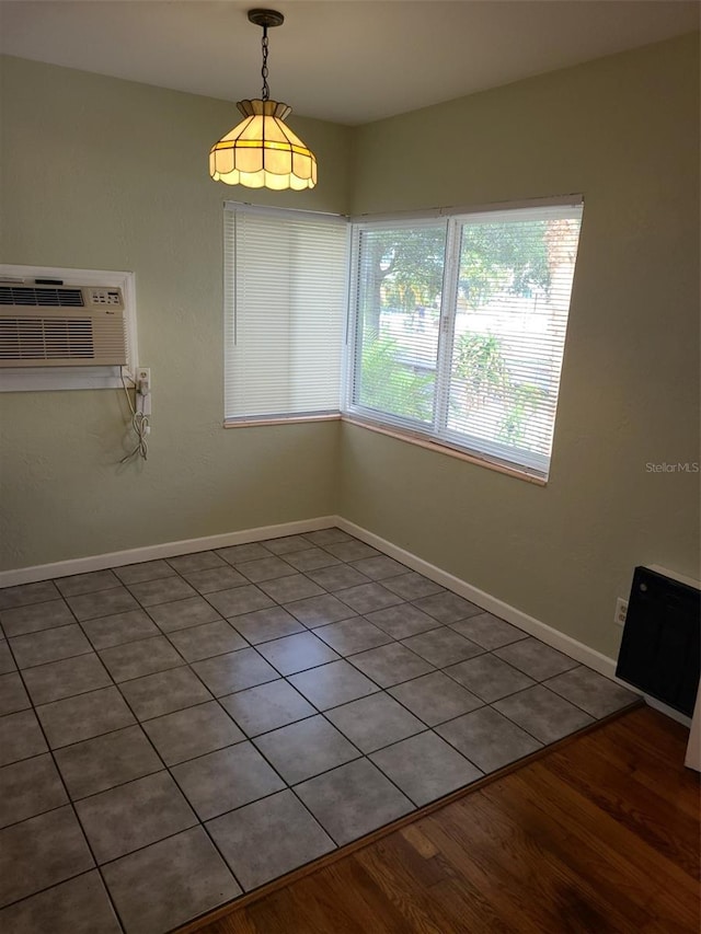 548 3rd St N, Saint Petersburg, FL 33701 - spare room featuring baseboards, a wall unit AC, and wood finished floors