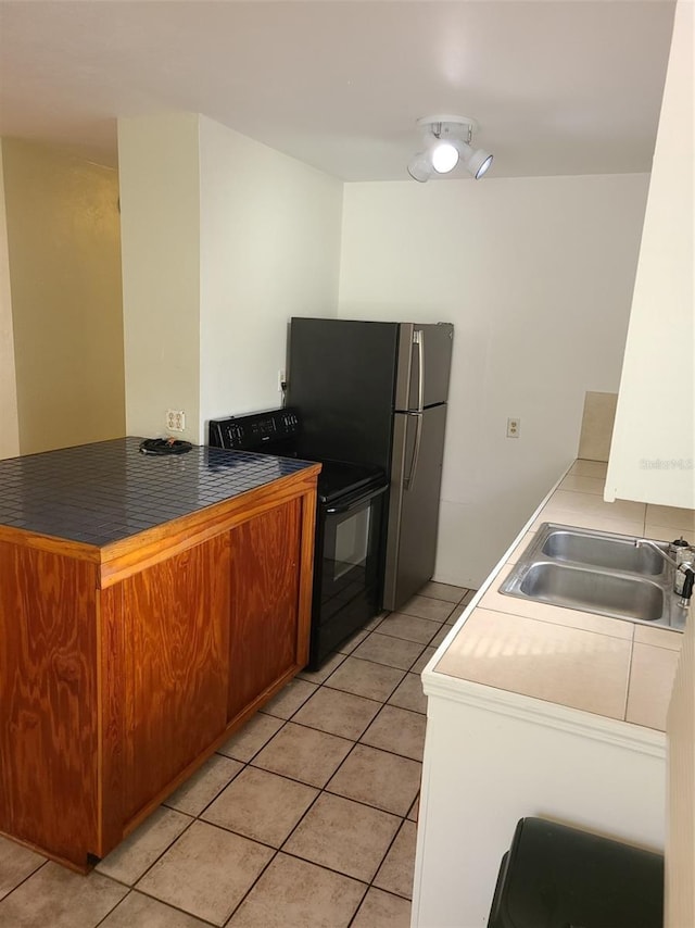 548 3rd St N, Saint Petersburg, FL 33701 - kitchen with a sink, dark countertops, a peninsula, electric range, and light tile patterned flooring