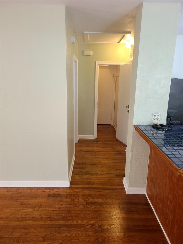 548 3rd St N, Saint Petersburg, FL 33701 - hall featuring dark wood-style floors, baseboards, and attic access