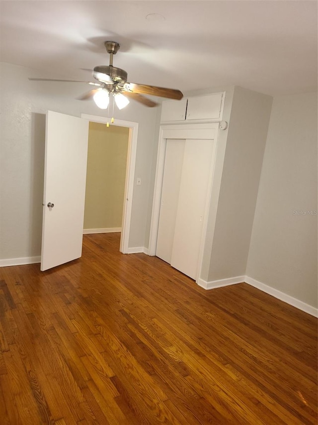 548 3rd St N, Saint Petersburg, FL 33701 - unfurnished bedroom with a closet, ceiling fan, baseboards, and wood finished floors