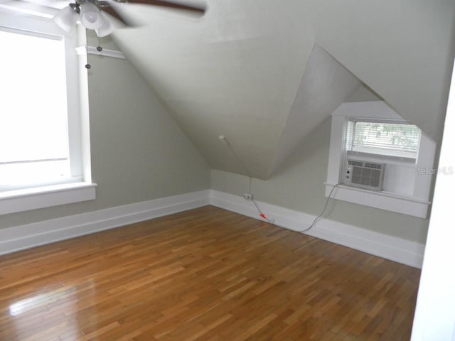 548 3rd St N, Saint Petersburg, FL 33701 - additional living space featuring baseboards, plenty of natural light, hardwood / wood-style flooring, and cooling unit
