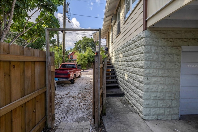 548 3rd St N, Saint Petersburg, FL 33701 - view of side of home featuring fence and stairs