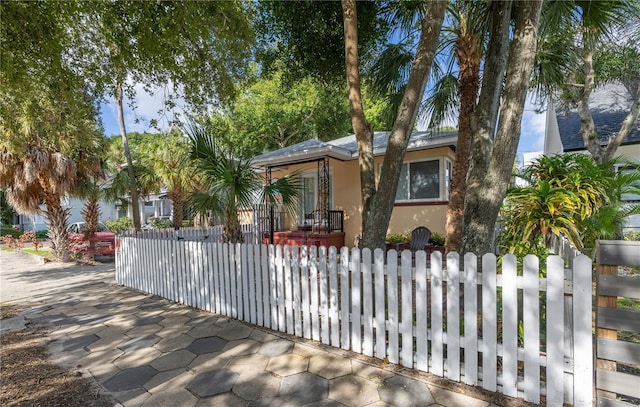 548 3rd St N, Saint Petersburg, FL 33701 - view of front of property with a fenced front yard and stucco siding