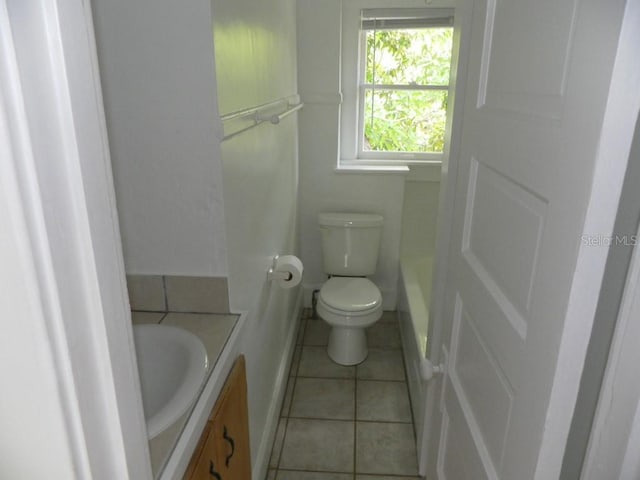 548 3rd St N, Saint Petersburg, FL 33701 - bathroom featuring tile patterned flooring, vanity, baseboards, and toilet