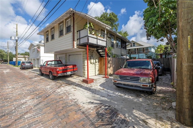 548 3rd St N, Saint Petersburg, FL 33701 - view of front of home with driveway, fence, and a garage
