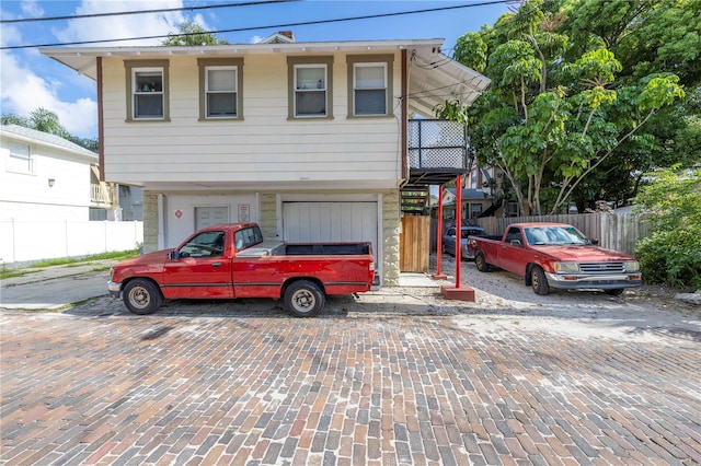 548 3rd St N, Saint Petersburg, FL 33701 - view of front of house with a garage, driveway, and fence