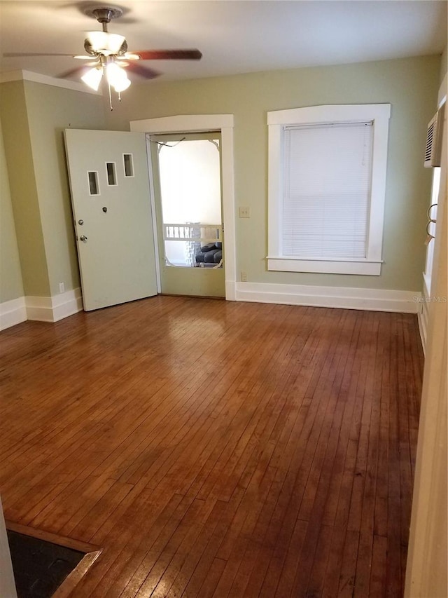 548 3rd St N, Saint Petersburg, FL 33701 - unfurnished living room featuring wood-type flooring, baseboards, and a ceiling fan