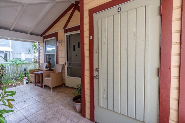 548 3rd St N, Saint Petersburg, FL 33701 - doorway to property featuring a porch and fence