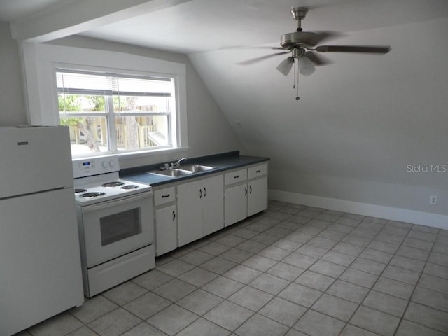 548 3rd St N, Saint Petersburg, FL 33701 - kitchen with white cabinets, a sink, dark countertops, white appliances, and vaulted ceiling